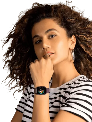curly hair girl wearing smartwatch and smiling